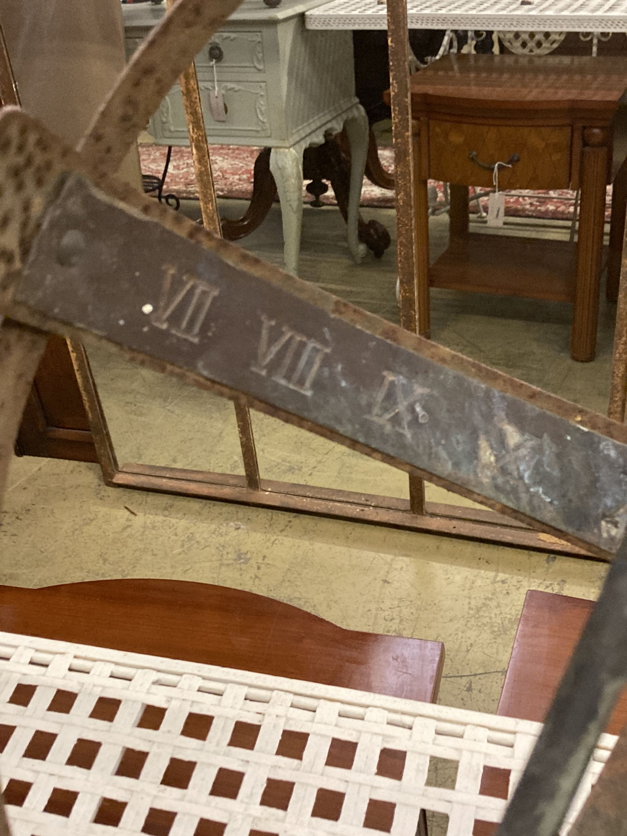 A wrought iron sundial, oval copper pan and five cast iron bootscrapers